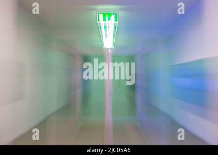 Illuminated Tunnel at Night with Exit Sign and with Light Effect in Switzerland. Stock Photo