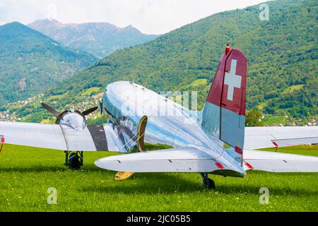 Old Elegant Airplane and Mountain in Locarno, Switzerland. Stock Photo