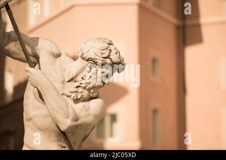 Neptune Statue Against an Old House on Piazza Navona in Rome, Italy. Stock Photo