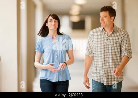 Couple walking in a corridor Stock Photo