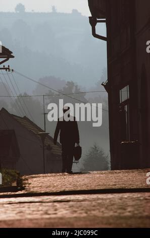 Silhouette of man walking on a down street, Prague, Czech Republic Stock Photo