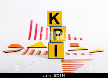 Key performance indicators. Failure in objectives achievement. Cubes with KPI text and graphs showing business decline. Strategic planning. High quality photo Stock Photo