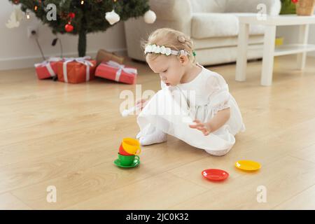 Child girl with cochlear implant plays at home. Hear impairment and diversity and hearing aid copy space and place for advertising Stock Photo