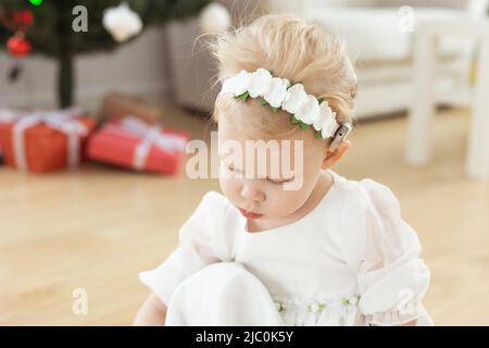 Child girl with cochlear implant plays at home. Hear impairment and diversity and hearing aid copy space and place for advertising Stock Photo