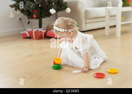 Child girl with cochlear implant plays at home. Hear impairment and diversity and hearing aid copy space and place for advertising Stock Photo
