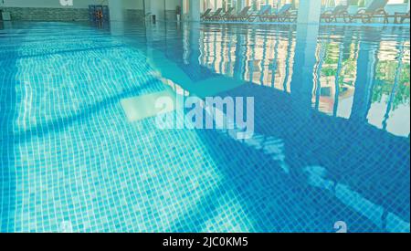 Water surface in an empty hotel swimming pool. Stock Photo