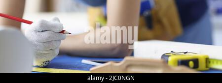 Woman worker making corrections in construction planning with pencil Stock Photo