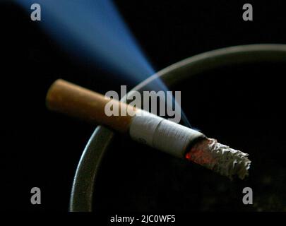 File photo dated 14/06/07 of a cigarette burning on an ash tray. The age at which people can legally buy tobacco in England should rise from 18 by one year every year, a Government-commissioned review has recommended. Issue date: Thursday June 9, 2022. Stock Photo