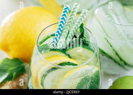 Detox refreshing sassy water with cucumber, ginger, mint and lemon in glasses, Healthy eating concept. Light background. Close-up. Body detoxication. Stock Photo