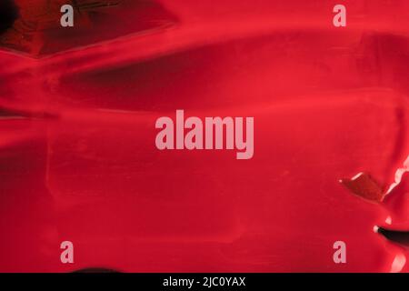 wet red paint splash on black background. Abstract vibrant background banner Stock Photo
