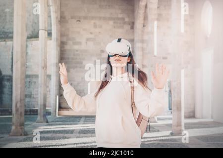 Woman wearing vr headset in european street, virtual travel concept Stock Photo