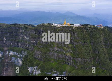 (220609) -- CHENGDU, June 9, 2022 (Xinhua) -- Aerial photo taken on June 6, 2022 shows the scenery of Mount Emei in southwest China's Sichuan Province. Mount Emei, located in southwest China's Sichuan Province, is an area of striking scenic beauty, notable for its lofty mountain and lush vegetation. It is also of great spiritual and cultural significance, in which there are archaeological sites, important architecture, tombs, ritual spaces, and collections of cultural artefacts, including sculpture, stone inscriptions, calligraphy, and paintings, among other traditional arts. Mount Emei is kn Stock Photo