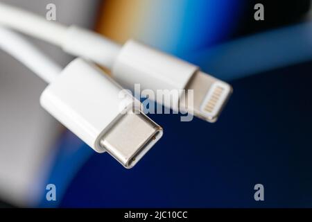 Close up of USB-C and Lightning male cables Stock Photo