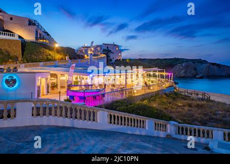 View of restaurant and whitewashed buildings at dusk in Arenal d'en Castell, Es Mercadal, Memorca, Balearic Islands, Spain, Europe Stock Photo