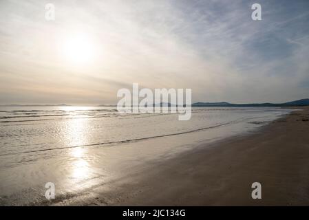 Low sunlight at Harlech Beach on the coast of North Wales. View north to the hills of the Lleyn Peninsula. Stock Photo