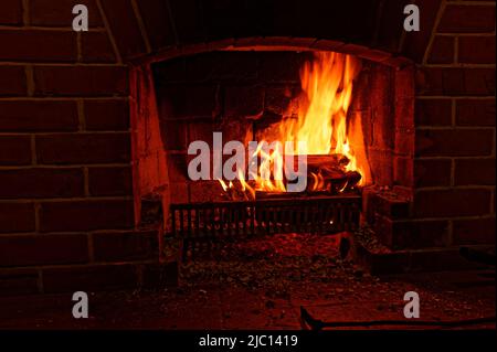 Winter warmth, an open fire burns brightly Stock Photo