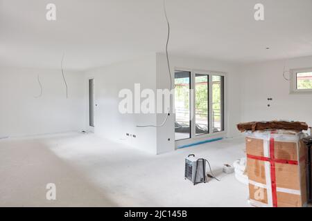 Living room with eat-in kitchen after painting work during renovation or new building Stock Photo