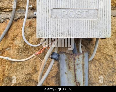 open cables on a telephone junction box on a house wall, Germany Stock Photo