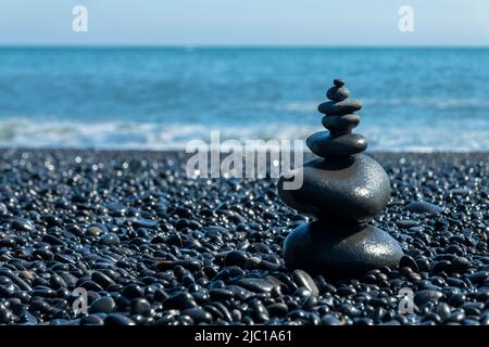 Balanced stones on Reynisfjara black beach in Iceland Stock Photo