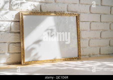 Photo frames on floor over white brick wall Stock Photo