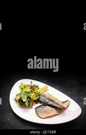 Two baked mackerel fillets on a plate Stock Photo