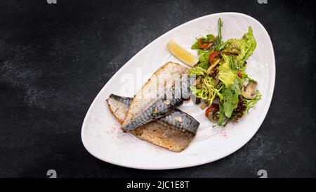 Two baked mackerel fillets on a plate Stock Photo