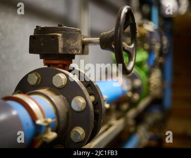 HDPE water pipe line in service access tunnel with cast iron isolation valve wheel. Stock Photo