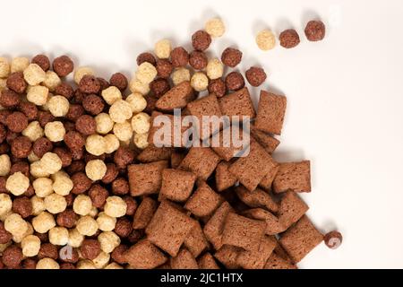 Quick breakfasts on white background - chocolate pads and balls, top view Stock Photo