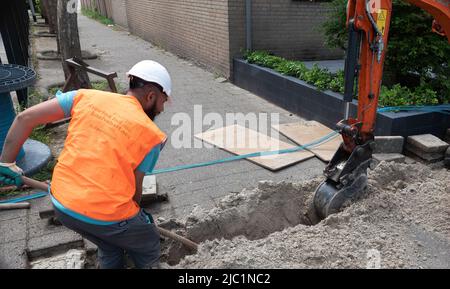 man digging a trench for the construction of fiber optic Stock Photo ...