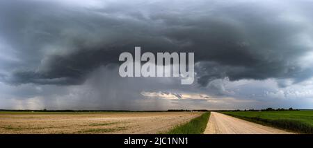 Storm clouds over field, extreme weather, dangerous storm Stock Photo