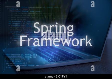 Spring framework inscription against laptop and code background. Technology concept. Stock Photo