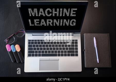 Top view of laptop with text machine learning. Machine learning inscription on laptop screen. Stock Photo