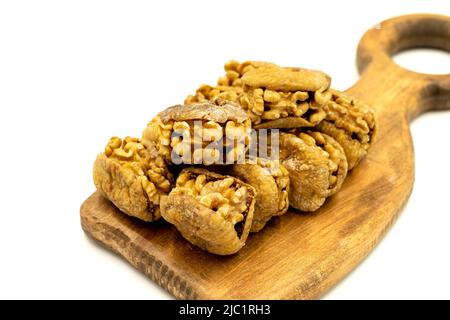Stuffed dried figs. Dried figs stuffed with walnuts isolated on white background. Close-up. local name cevizli incir Stock Photo