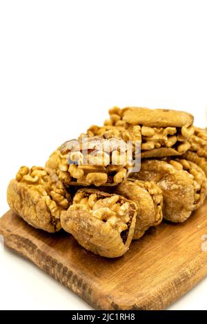 Stuffed dried figs. Dried figs stuffed with walnuts isolated on white background. Close-up. local name cevizli incir Stock Photo