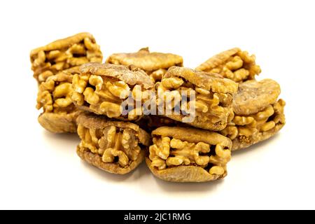 Stuffed dried figs. Dried figs stuffed with walnuts isolated on white background. Close-up. local name cevizli incir Stock Photo