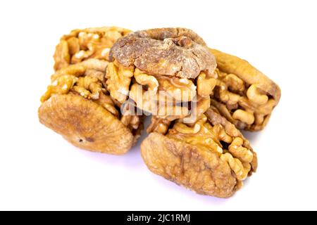 Stuffed dried figs. Dried figs stuffed with walnuts isolated on white background. Close-up. local name cevizli incir Stock Photo