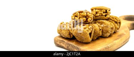 Stuffed dried figs. Dried figs stuffed with walnuts isolated on white background. Close-up. Copy space. local name cevizli incir Stock Photo