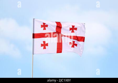 The flag of Georgia is a white banner with five red crosses Stock Photo