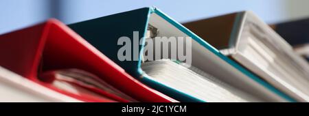 Stack of colourful folders for documents on table Stock Photo