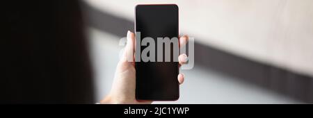 Woman hold smartphone with locked or turned off black screen Stock Photo