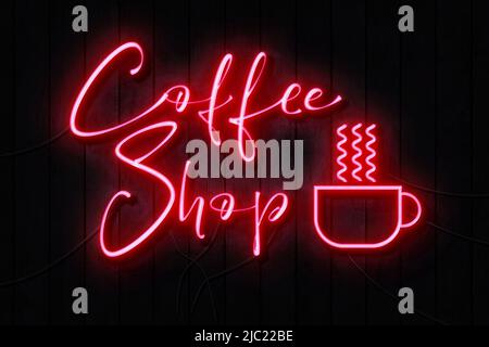 Coffee Shop Neon Sign on a Dark Wooden Wall Stock Photo