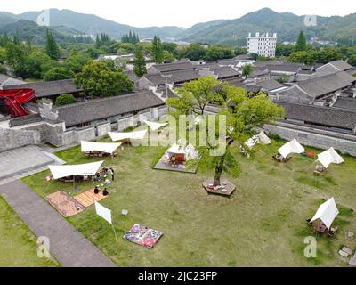 (220609) -- HANGZHOU, June 9, 2022 (Xinhua) -- Aerial photo taken on May 19, 2022 shows a camping area in Ningbo, east China's Zhejiang Province. In June 2021, China's central authorities issued a guideline on building Zhejiang into demonstration zone for achieving common prosperity. Under the guideline, the province will strive to achieve common prosperity by 2035, with its per capita gross domestic product and the income of urban and rural residents reaching the standard for developed countries. As an economic powerhouse in east China, Zhejiang Province has drawn up detailed plans to ach Stock Photo
