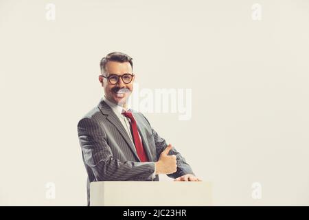 Portrait of smiling businessman wearing grey striped suit in 50s, 60s fashion style isolated on white background. Retro vintage style, business, ad Stock Photo