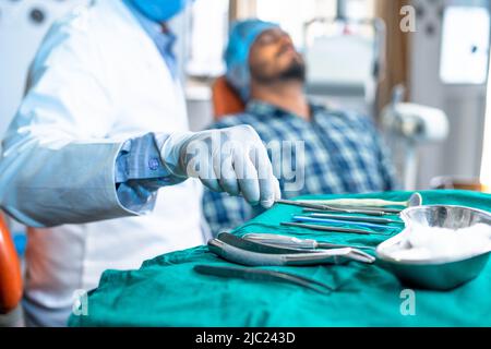 Close up shot of dentist using medical equipment for teeth or oral treatment at hospital - concept of expertise, professional occupation and dental Stock Photo