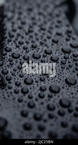 Close up on ideal water drops after rain on car body Stock Photo