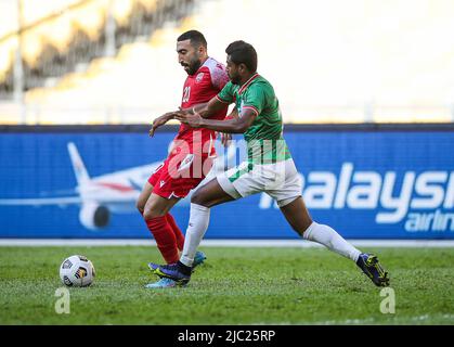 Kuala Lumpur, Malaysia. 08th June, 2022. Mahdi Faisal Alhumaidan (L) of Bahrain and Md Rimon Hossain (R) of Bangladesh in action during the AFC Asian Cup 2023 qualifiers match between Bahrain and Bangladesh at the National Stadium Bukit Jalil. Final score; Bahrain 2:0 Bangladesh. Credit: SOPA Images Limited/Alamy Live News Stock Photo