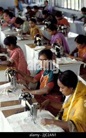 Bangladesh; portrait of a woman working with a sewing machine. Textile factory. Stock Photo