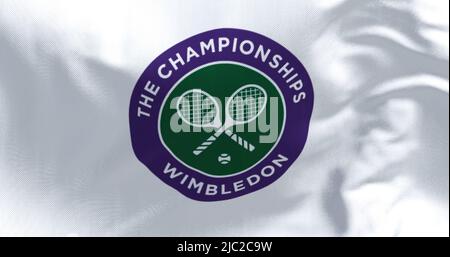 London, UK, April 2022: Close up of The Championships Wimbledon flag waving in the wind. Wimbledon Championships is a major tennis tournament schedule Stock Photo