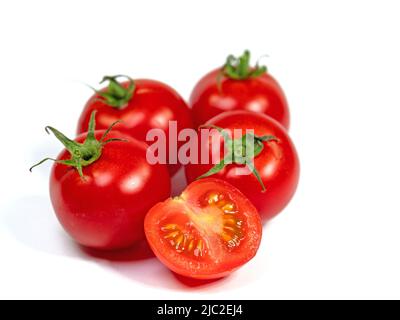 Vine tomatoes isolated against white background Stock Photo - Alamy