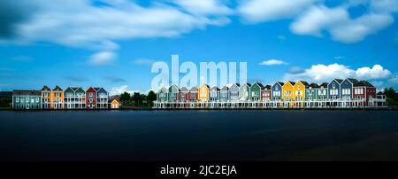 Houten, Netherlands - 9 June, 2022: panorama view of the colorful rainbow houses and lake in Houten Stock Photo